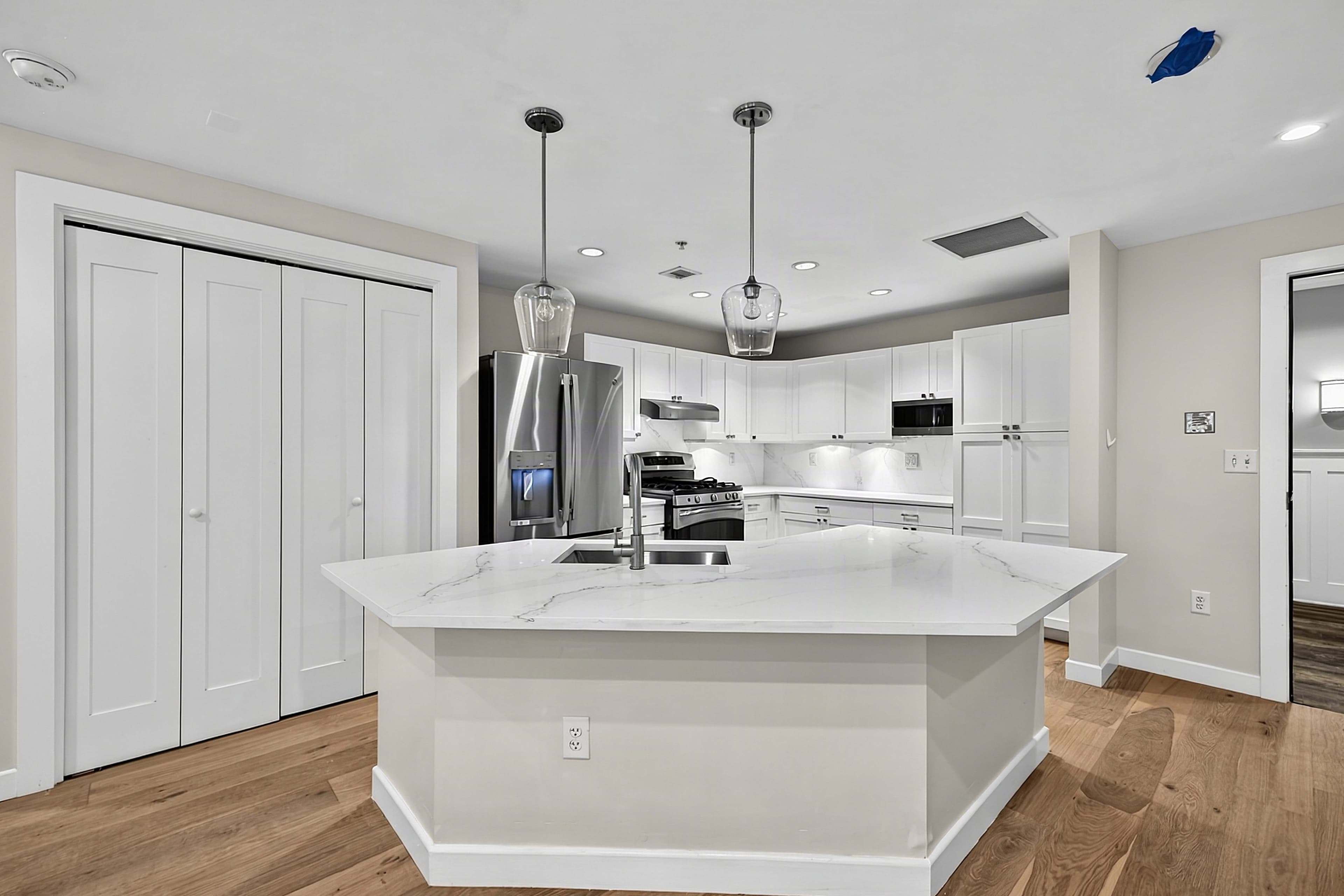 Renovated apartment kitchen with a white island